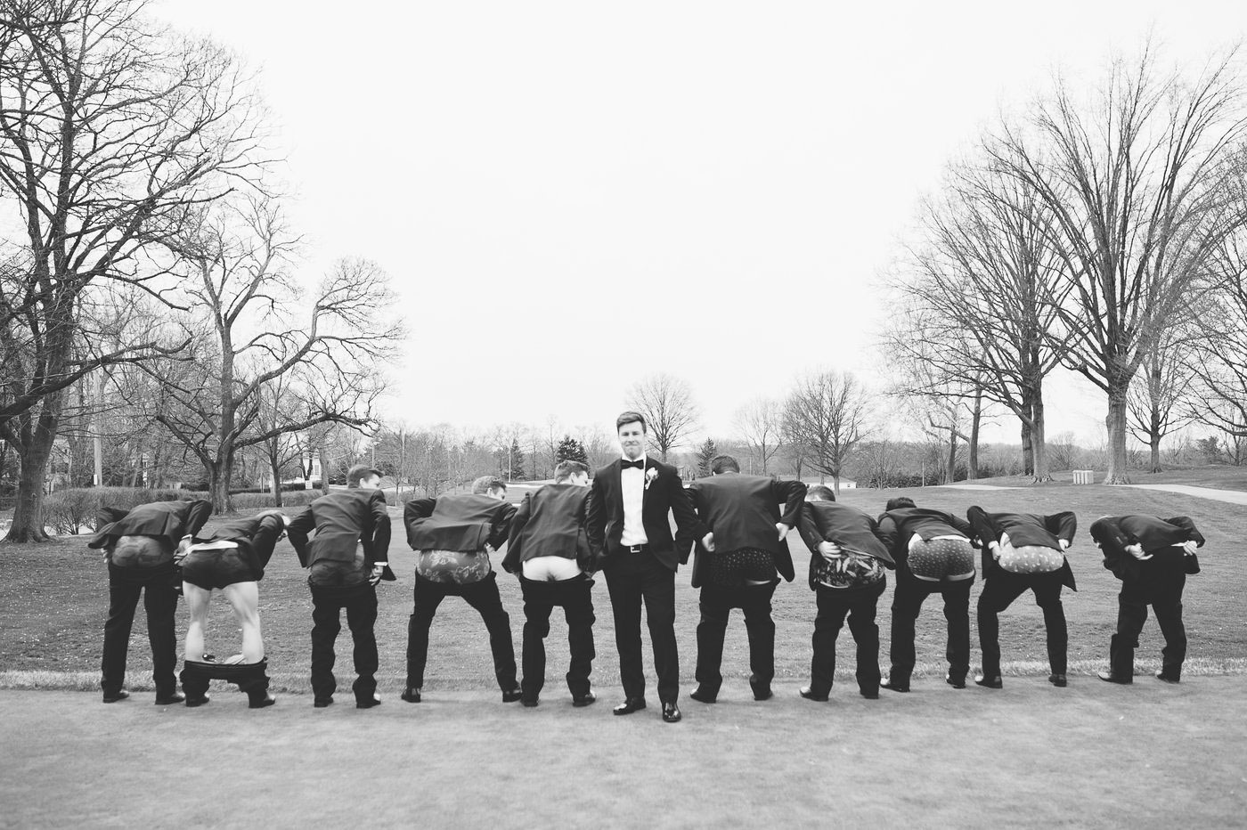 black and white groomsmen portraits on golf course