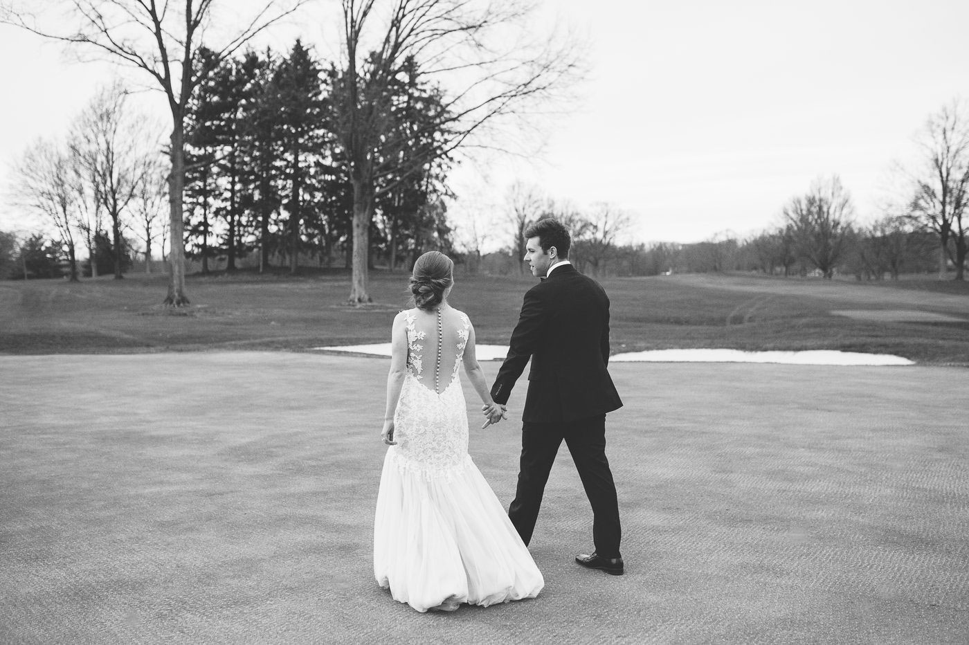 black and white bride and groom sunset portraits on golf course